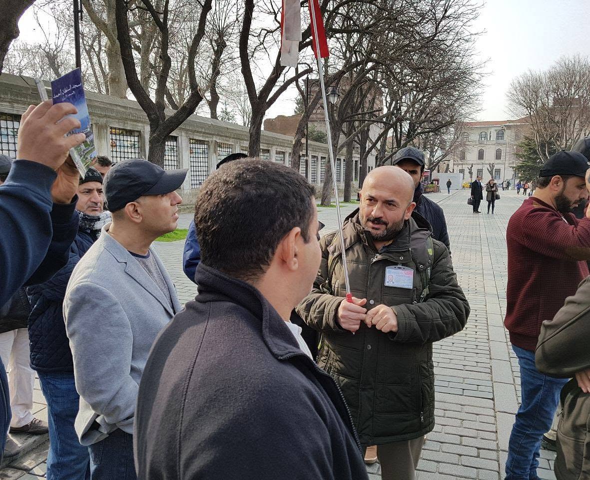 Adnan Yılmaz guiding a small group during a cultural visit