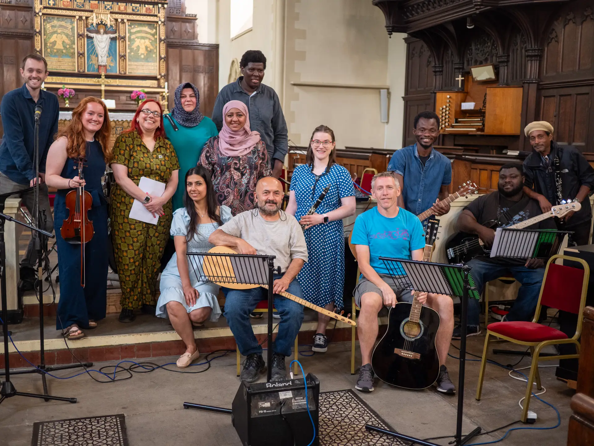 A community music group posing together with instruments