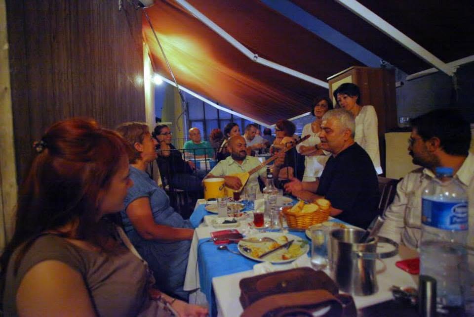 People sharing a meal together around a long table